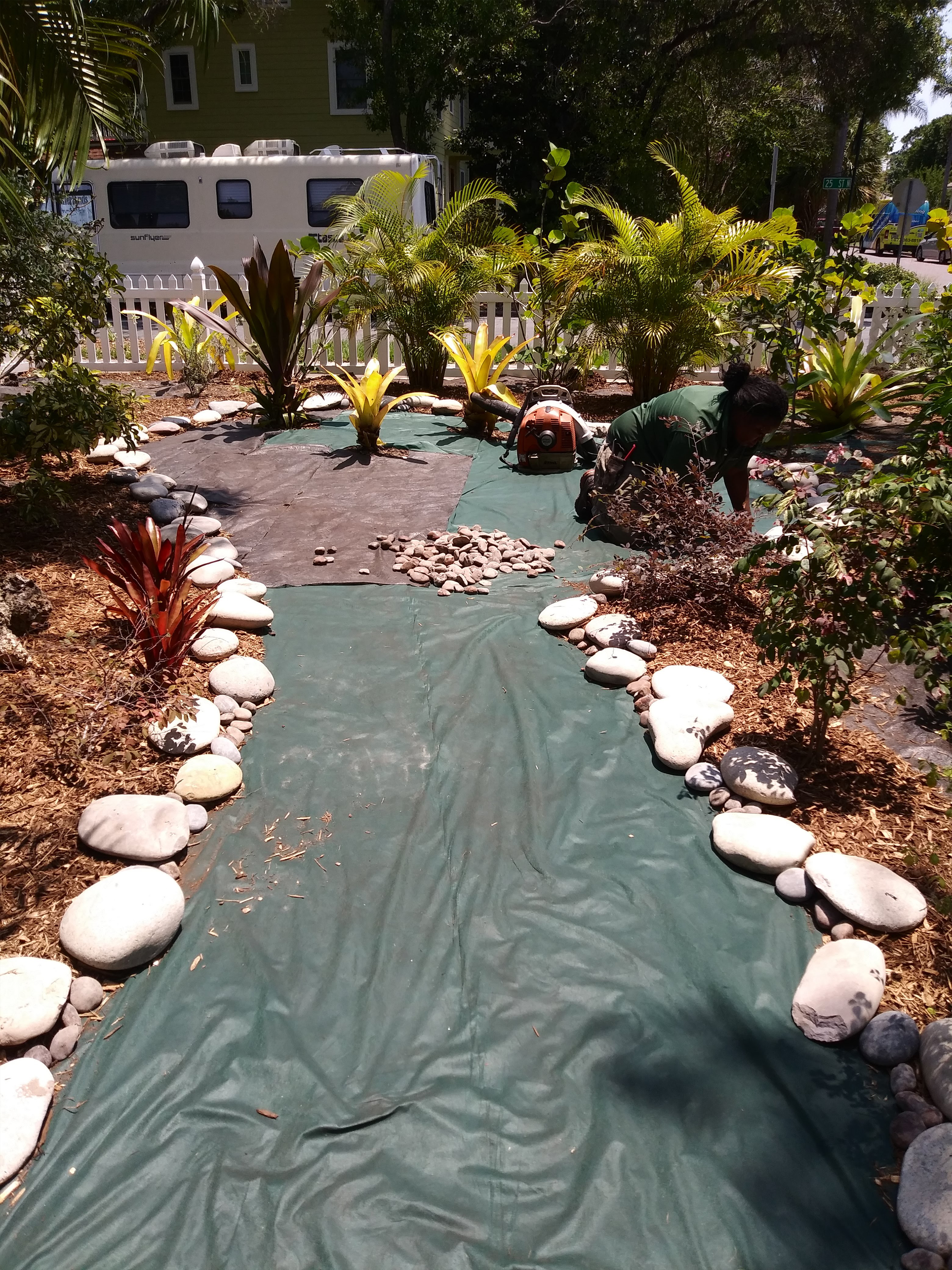 A Peaceful Garden Scene With Lush Plants and Smooth Rocks